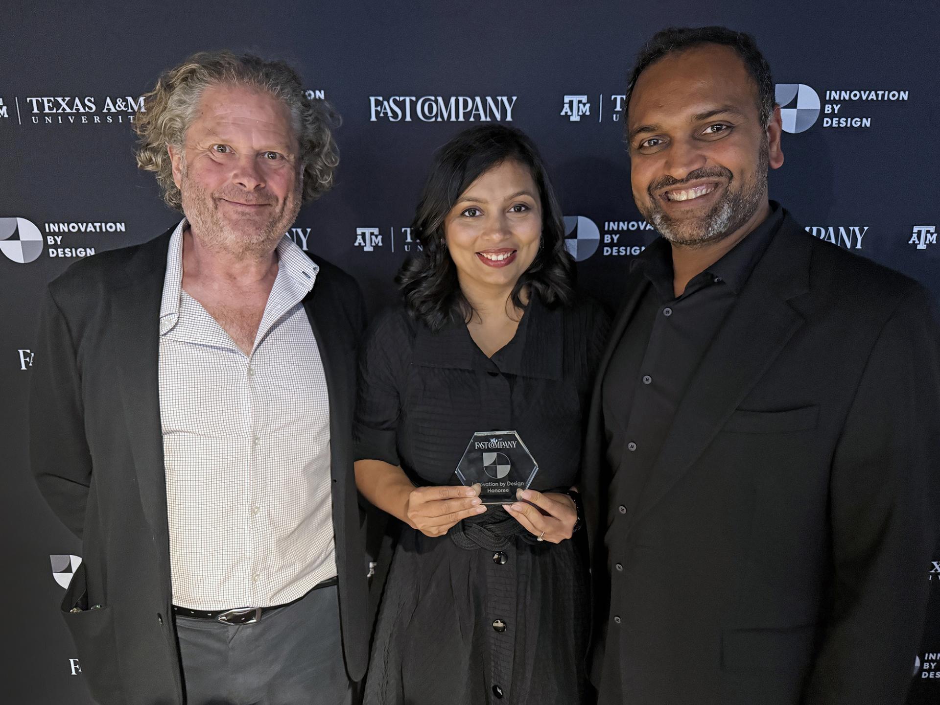 Chris Matthews, Devanshi Purohit, and Kishore Varanasi pose with CBT's Fast Company award
